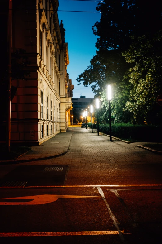 an empty street at night on a clear evening