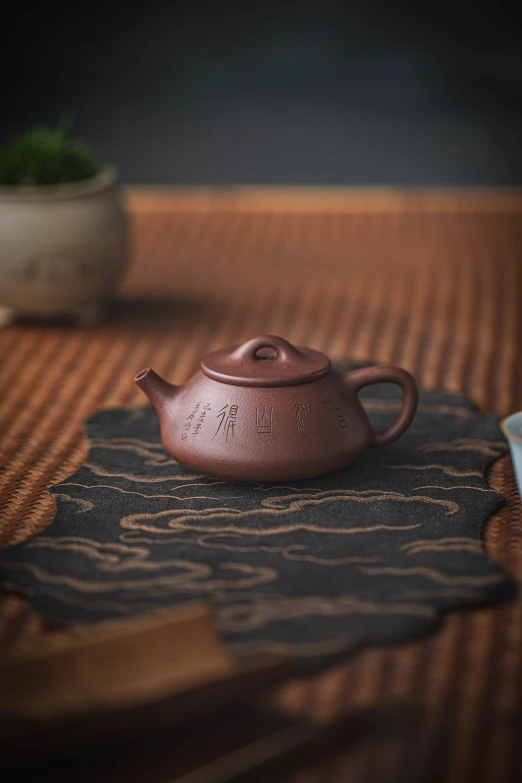 a tea pot sitting on top of a wooden table