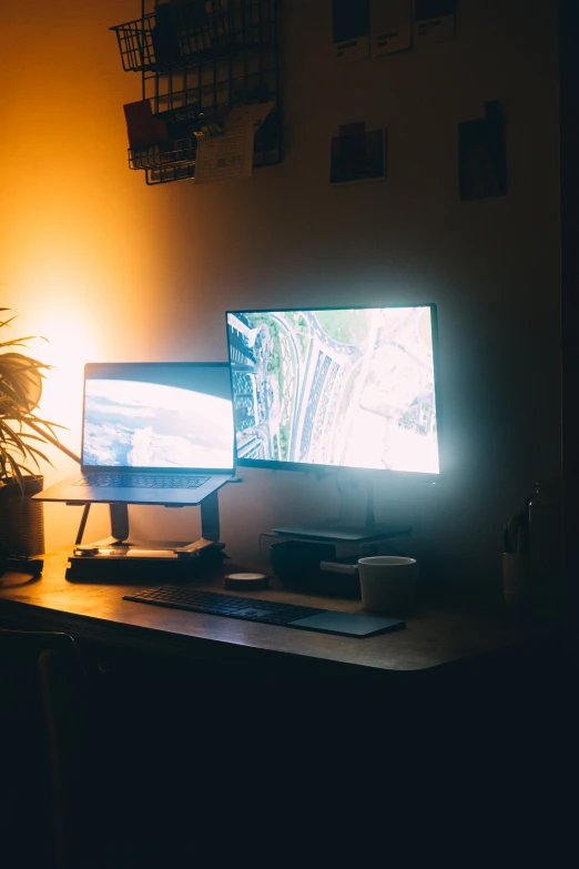 two desktop monitors and a keyboard are on the desk