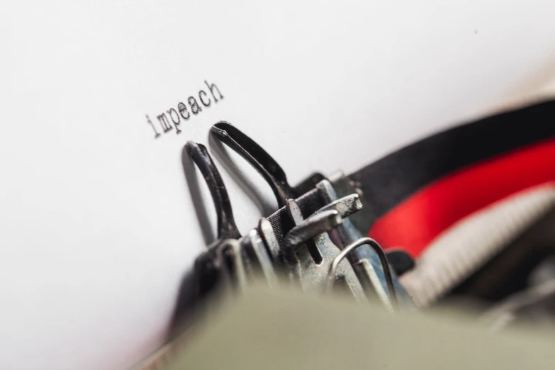 an old typewriter is sitting beside some books and a pair of scissors