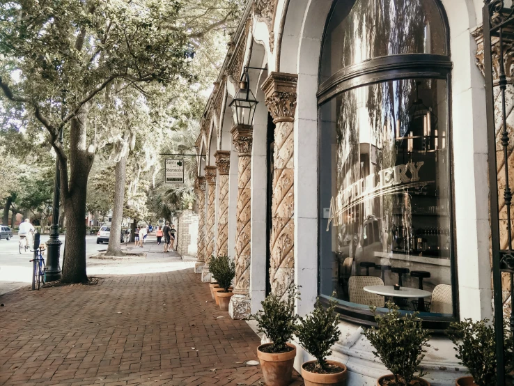 the front of a store is covered by brick walkway