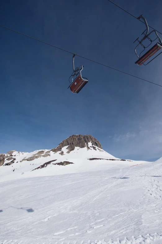 a ski lift going over a snowy mountain