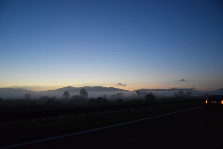 fog rolling in from the distance along a highway