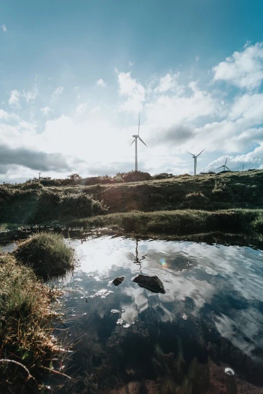 a wind farm with wind turbines in the background