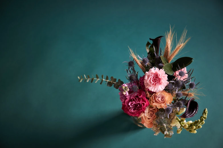 a group of different colored flowers arranged in a bouquet