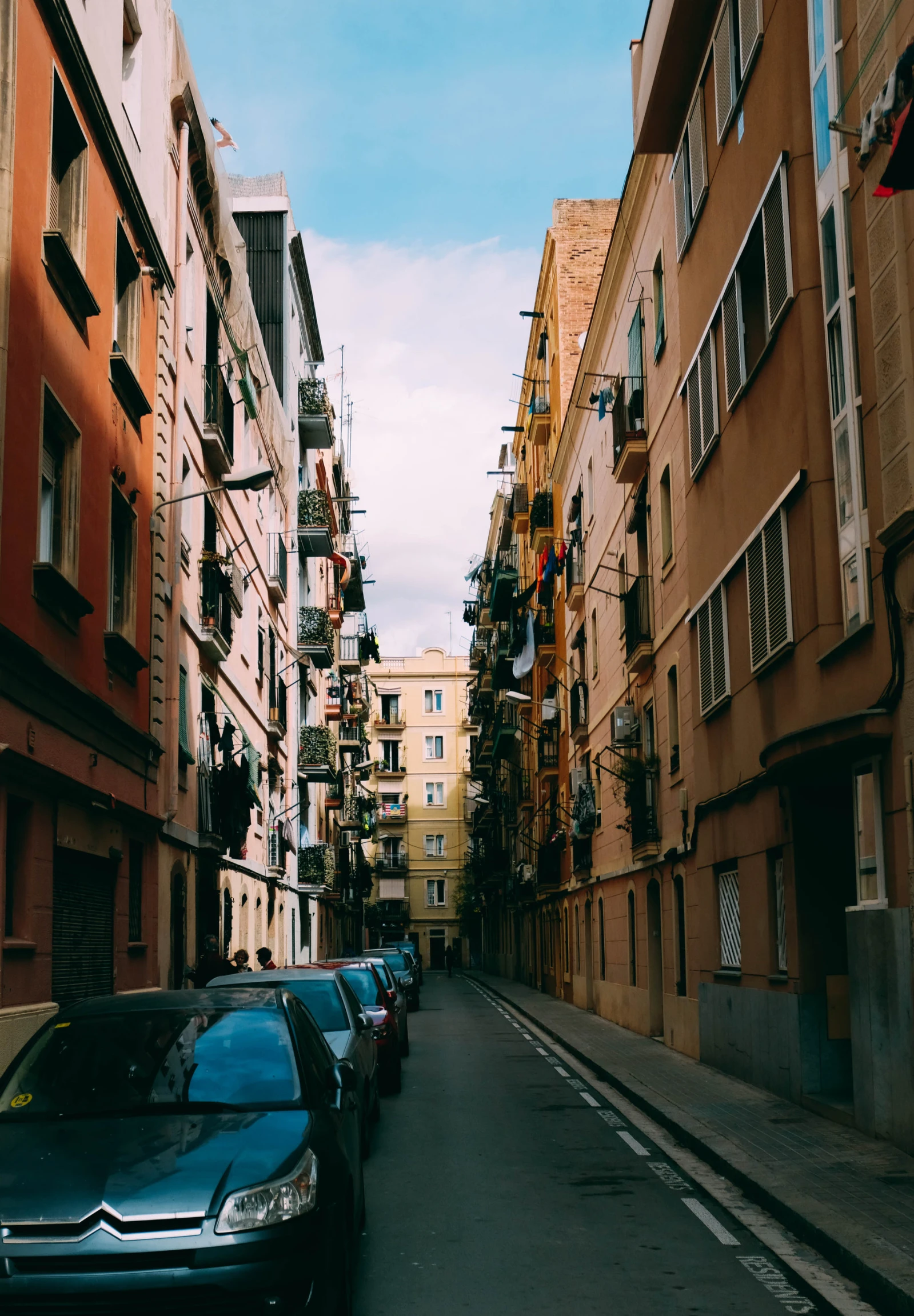 a road is lined with cars and buildings