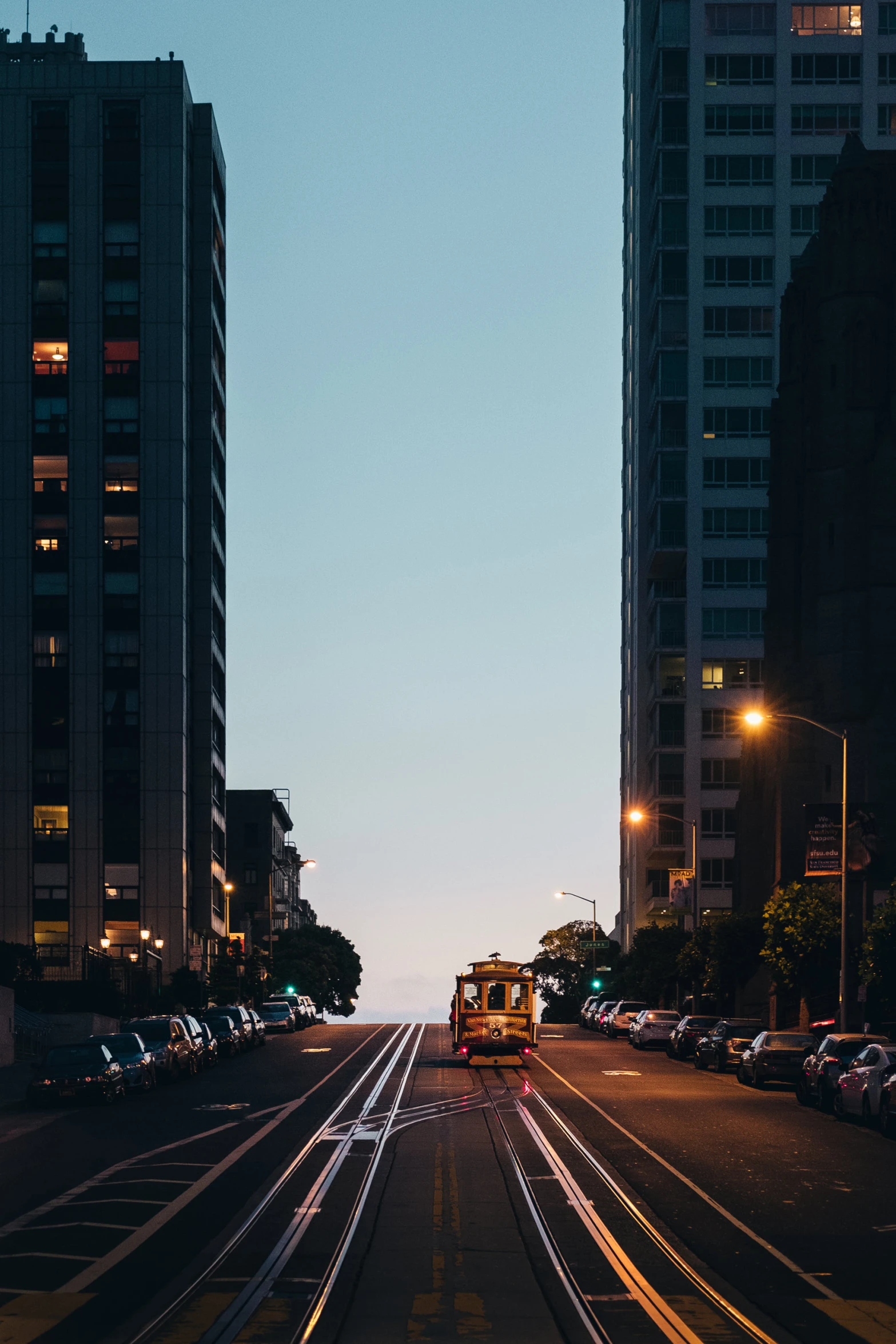 train tracks through a city street at twilight