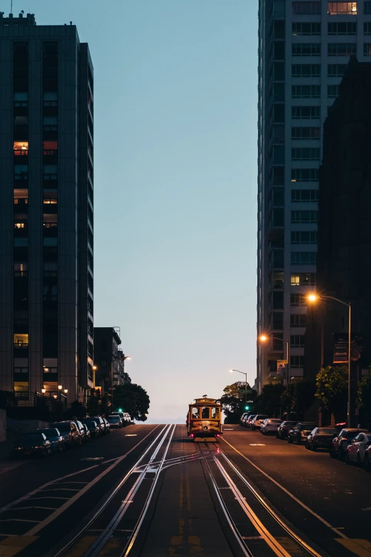 train tracks through a city street at twilight