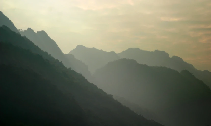 this is a blurry image of mountains on a misty day