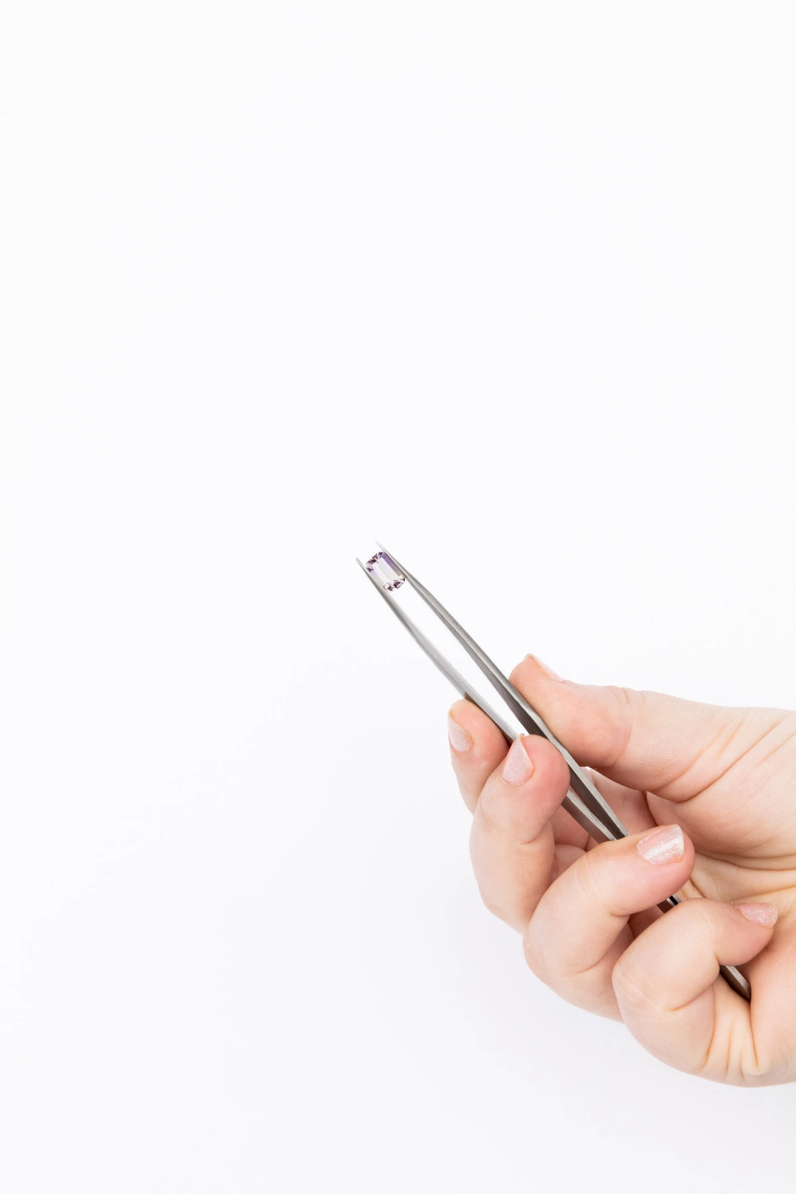 a woman is holding her cellphone on a string