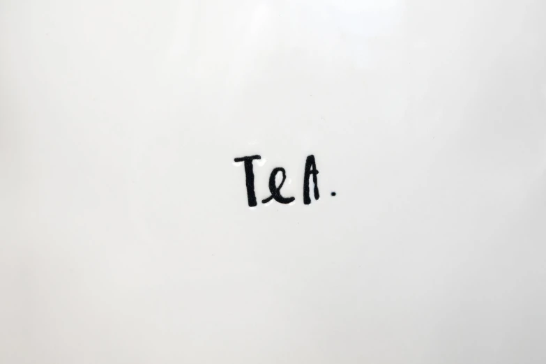 the letters tea are spelled in black ink