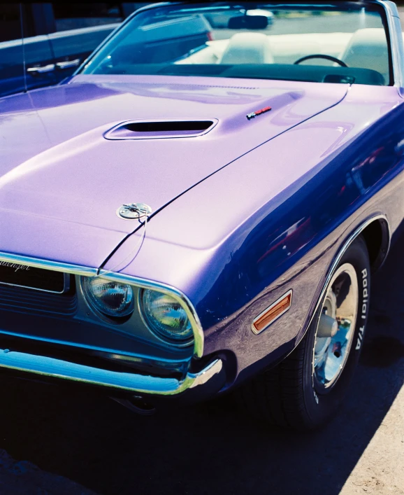 a purple classic car parked in a parking lot