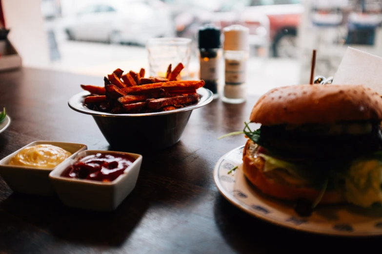 there is a hamburger and french fries on the table