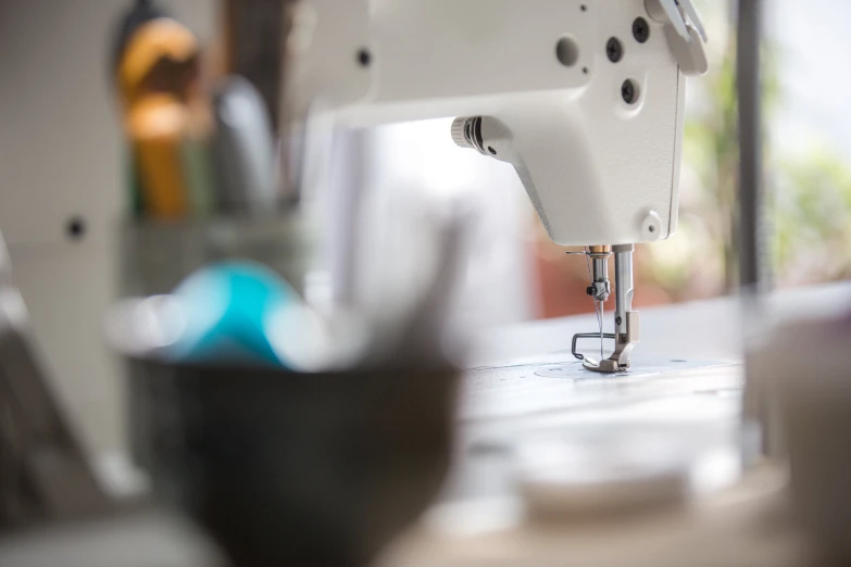 close up image of sewing machine on table