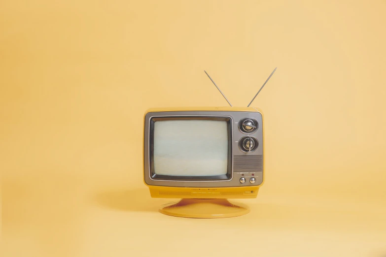 an old fashioned tv sitting on top of a wooden stand