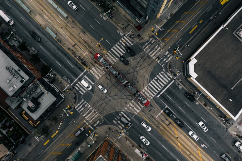 an aerial view shows cars, buses and pedestrian traffic on a street