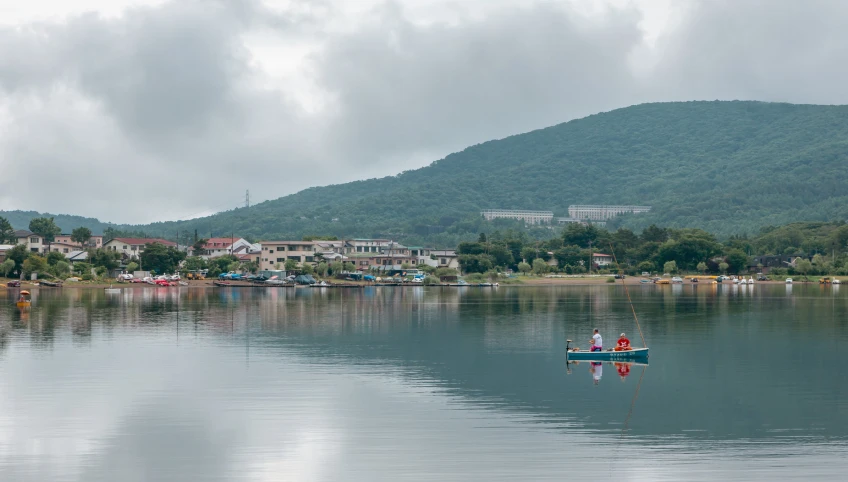 a small boat floating on the water next to a village