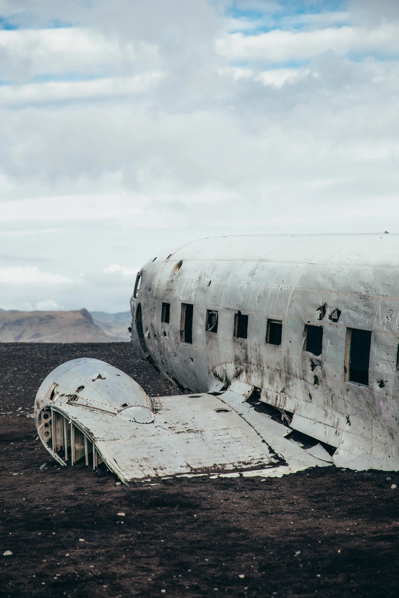 an old propeller airplane sits on the ground