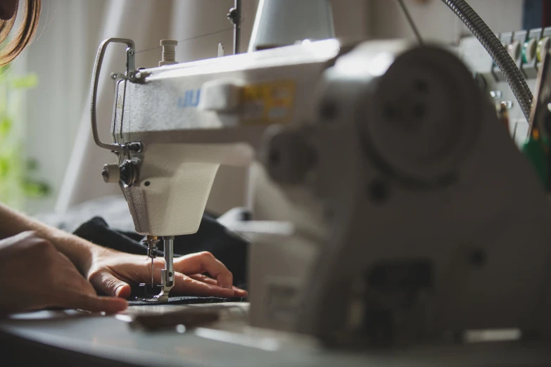 a sewing machine with woman working on it