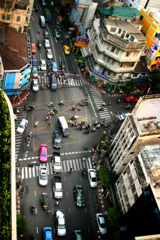 a street filled with lots of traffic next to tall buildings