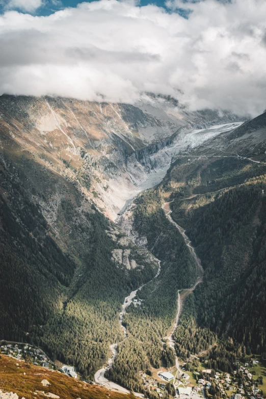 the view from the top of a high mountain looks down on a valley