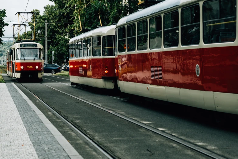 an old style red and white trains on tracks