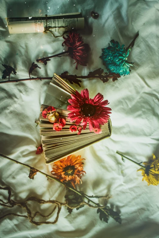 a bed topped with lots of different types of flowers