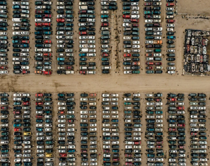 an aerial s of a parking lot with many different vehicles parked