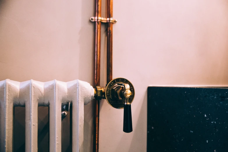 an electric heating radiator near a water heater