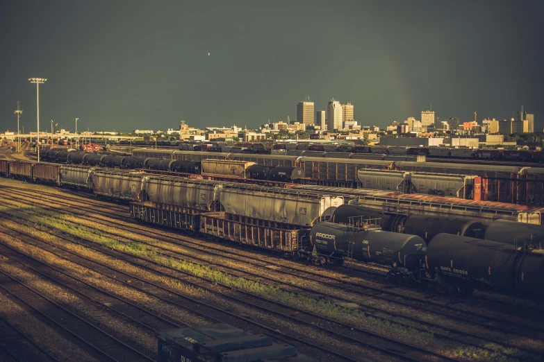 train yard and railway cars on elevated tracks with the skyline in the background