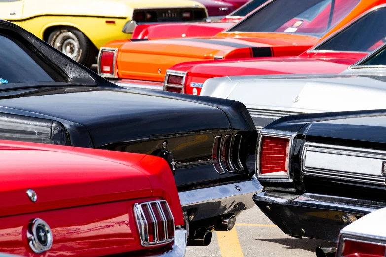 several classic cars lined up next to each other