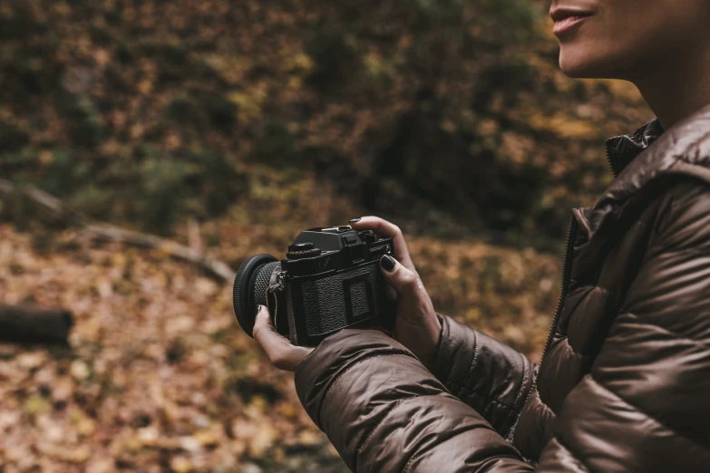 a woman holds an electronic device in her hands