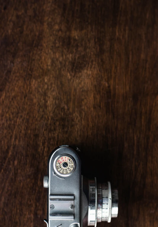 an old po camera is laying on a brown table