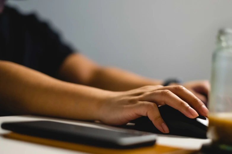 a hand is on top of the keyboard of a computer