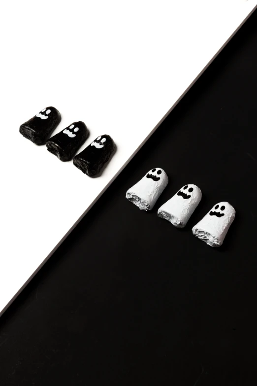 three white and black items displayed on a table