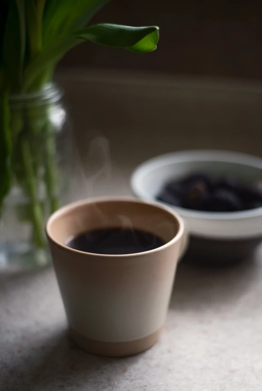 a vase and cup with smoke in it