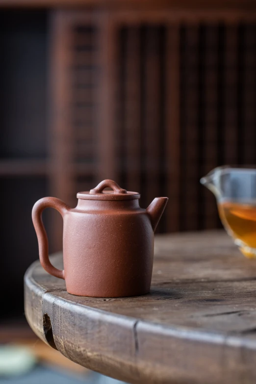 a teapot sitting on top of a wooden table