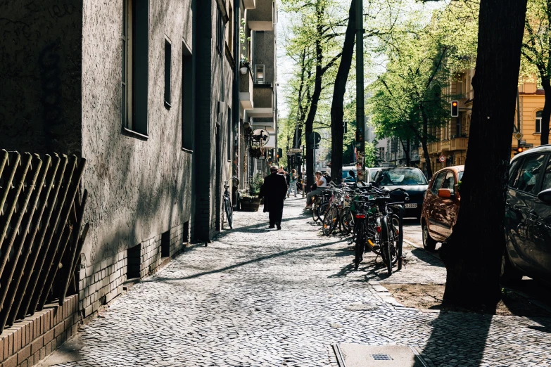 a person walking down the sidewalk with their bicycle