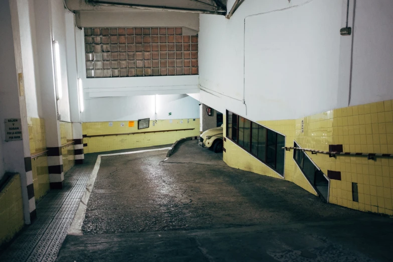 an empty parking garage with yellow painted walls