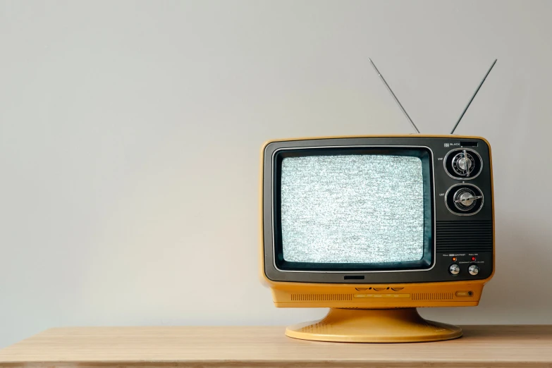 a vintage television sits on top of a table