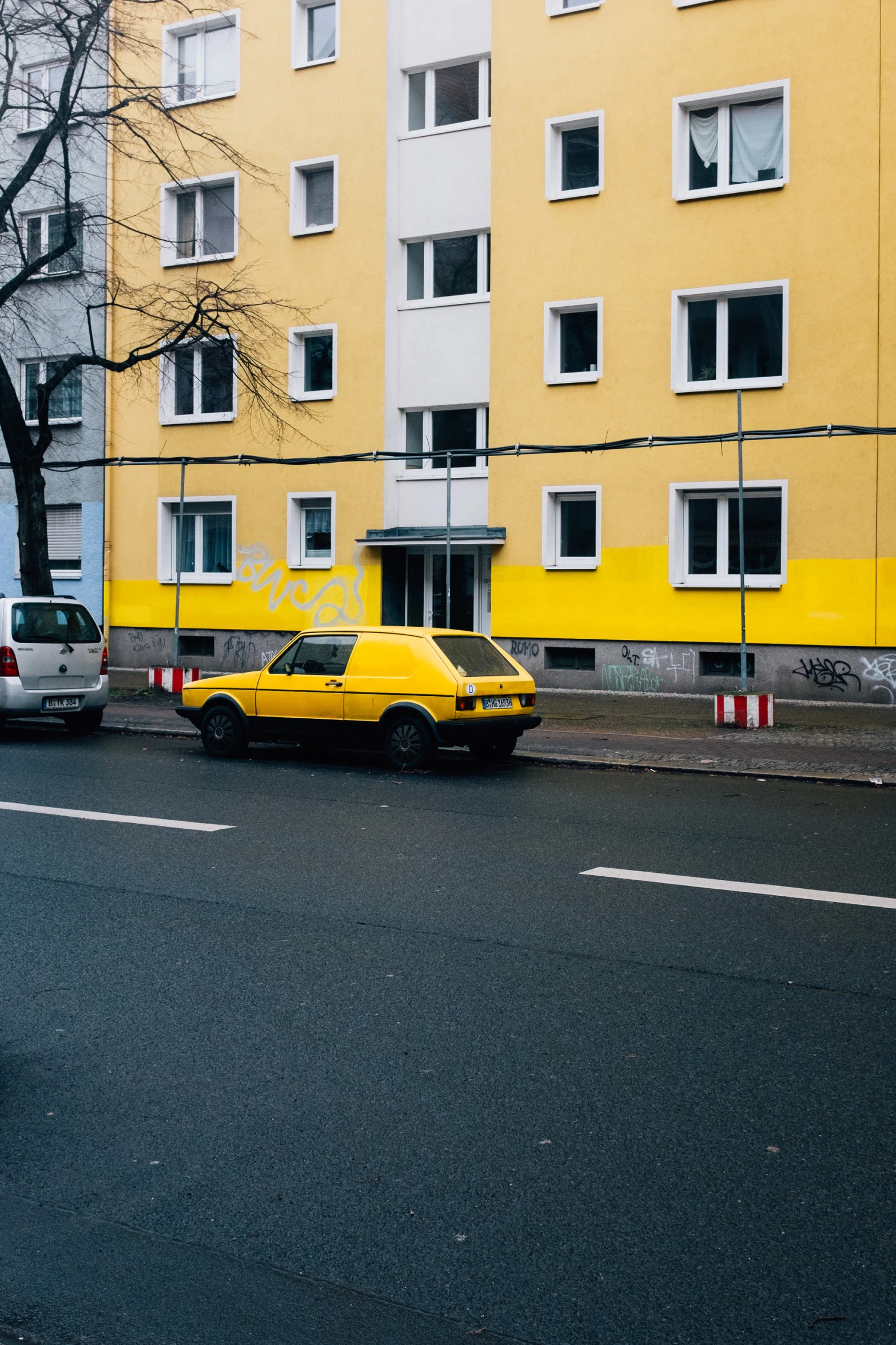 a very long row of yellow cars parked on a street