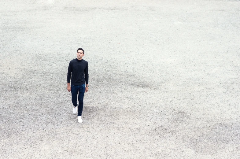 a man standing alone in the middle of a parking lot