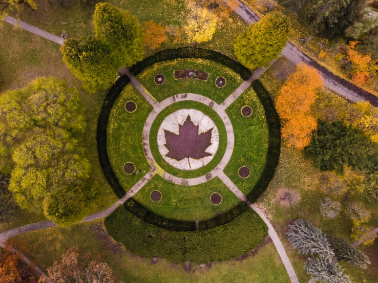 an aerial view shows the circle - like motif of a park surrounded by trees