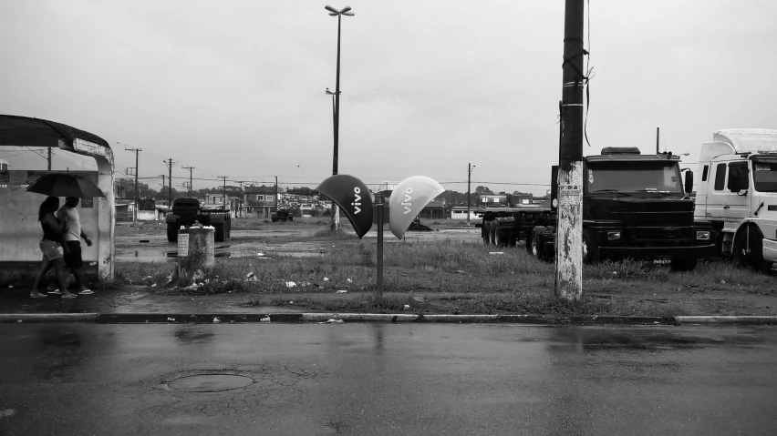 a group of people and trucks in a parking lot