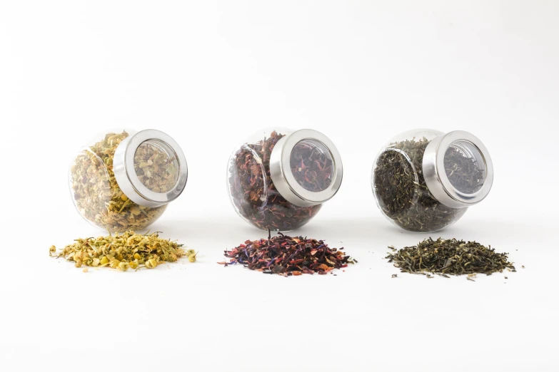 five different kinds of loose tea and spice are shown