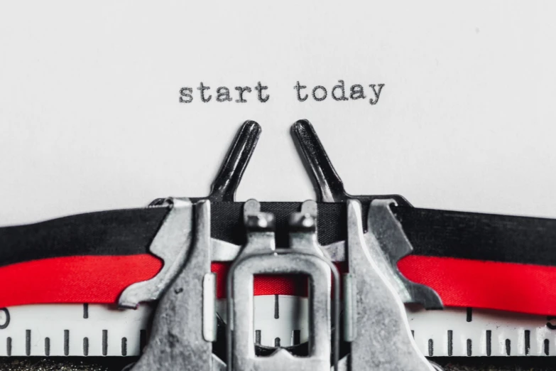 the words start today on a typewriter with scissors