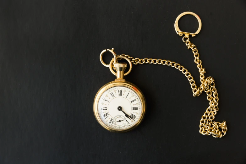 a key chain with an antique pocket watch