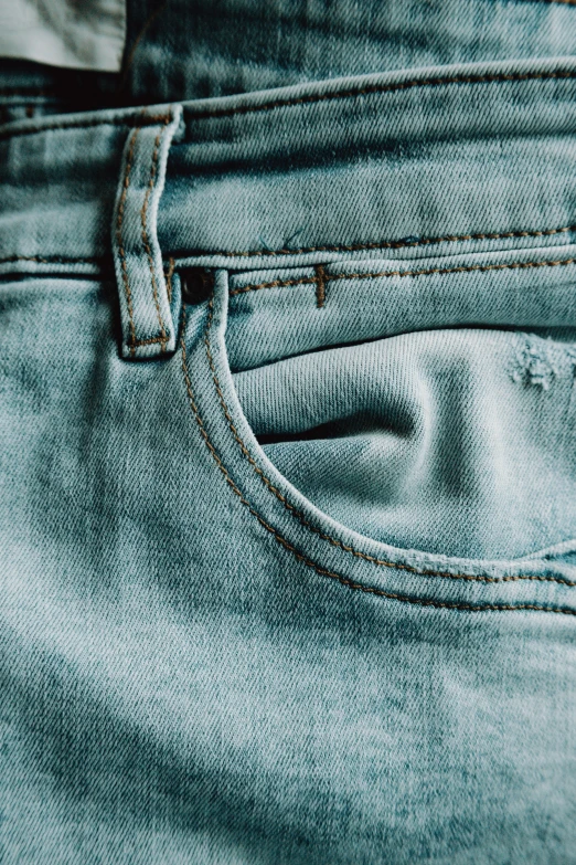 closeup on blue jean shorts with the back pocket open