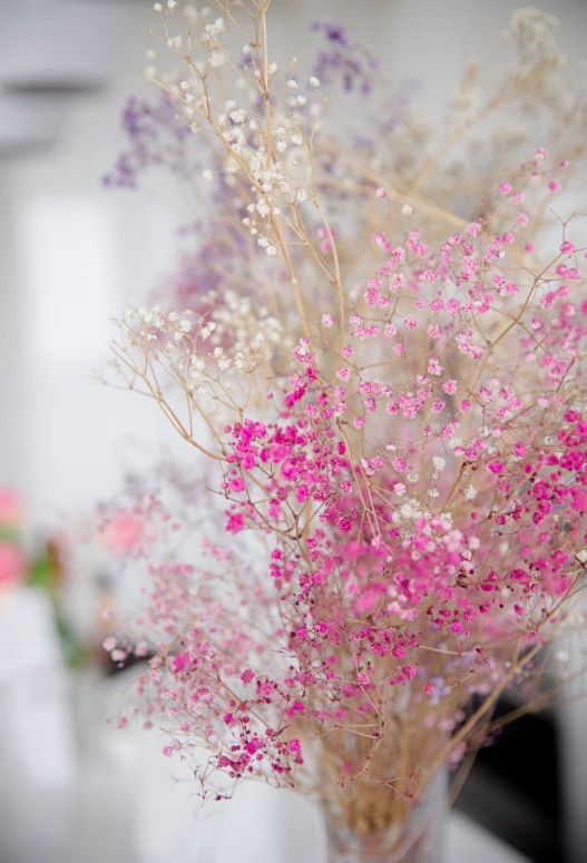 there is a vase with some pink and white flowers