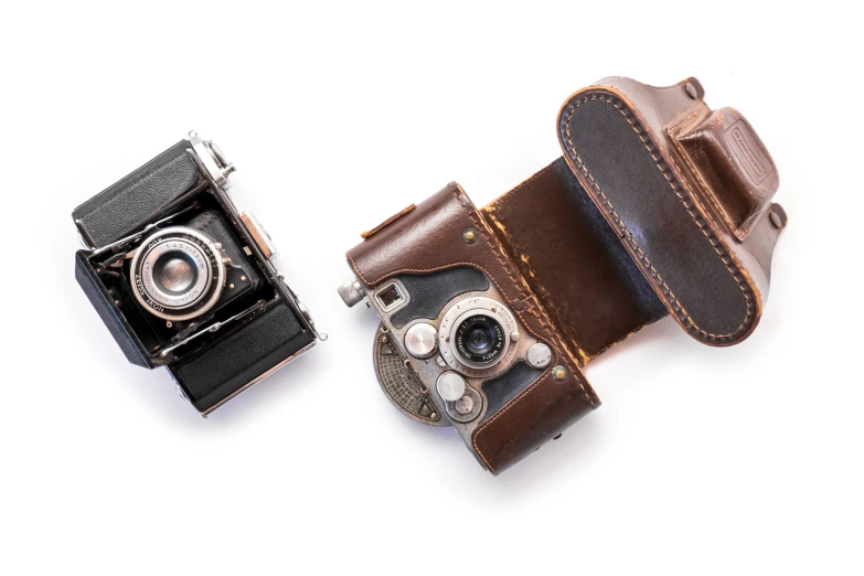 a camera and a leather case sitting next to each other